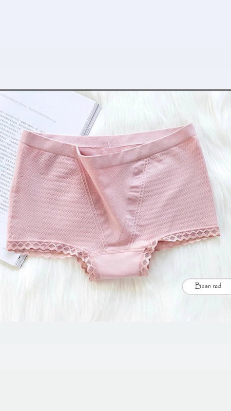 Pink underwear with lace trim on a white surface