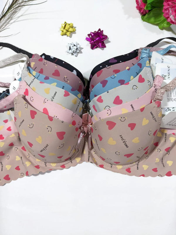 Set of colorful bras with heart patterns on a white background